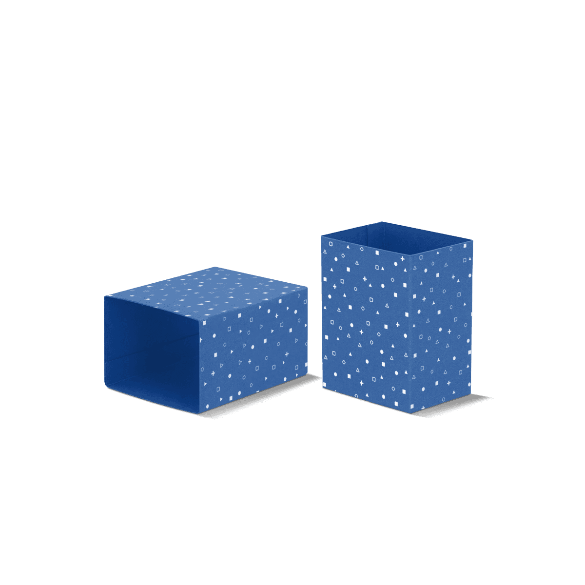 Cardboard packaging sleeves in printed kraft and white board, arranged around small product boxes with visible fold lines and clean finishes.