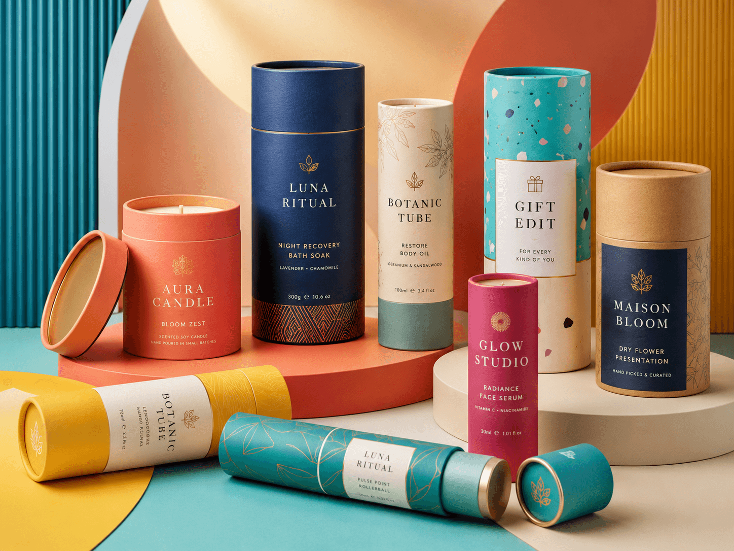 Custom cardboard tube packaging with printed paper finishes and fitted lids.